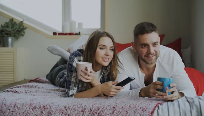 Happy couple watching British IPTV Smarters Pro UK on their Smart TV